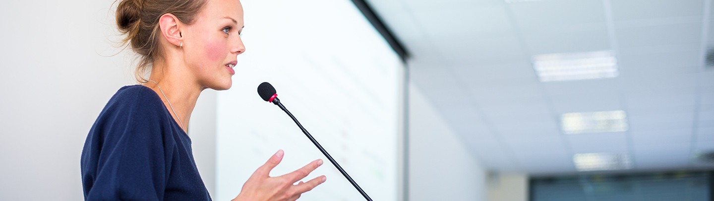 Woman speaking at a podium