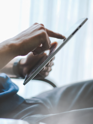 Care coordination within a clinically integrated network Person working on their tablet